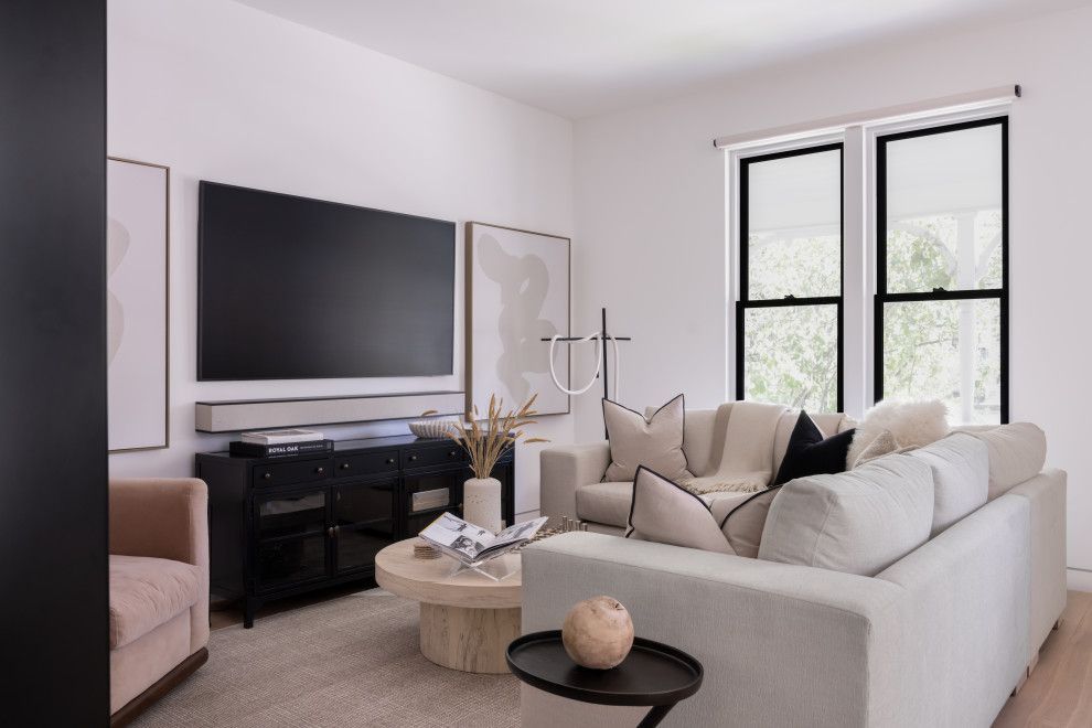 A living room with a white couch and a flat screen tv.