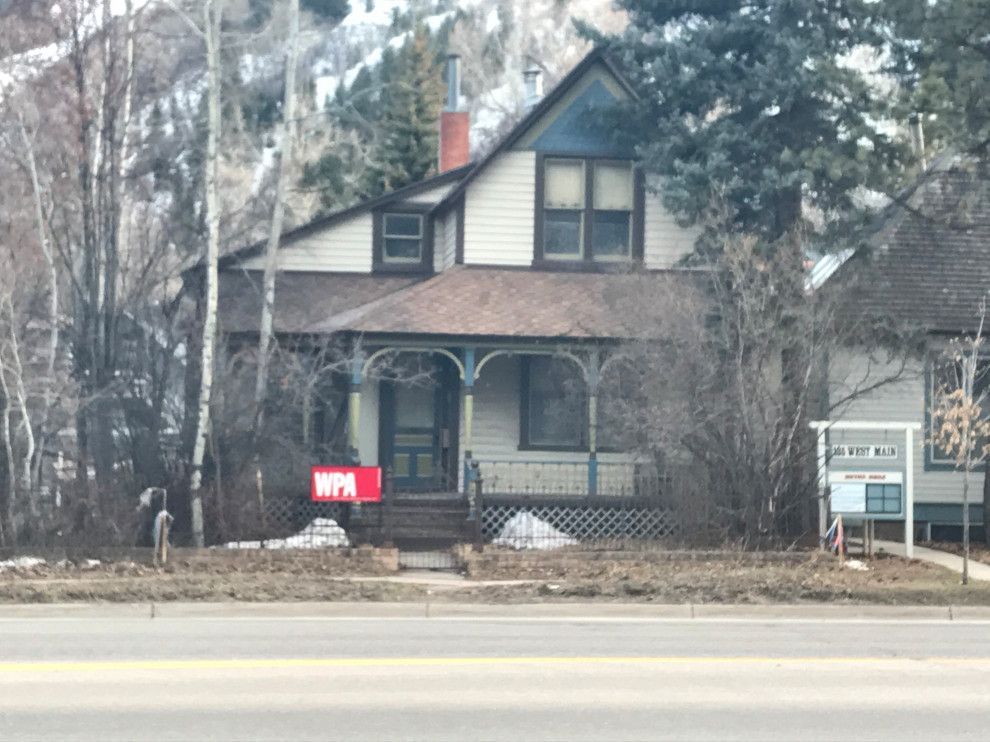 A house with a for sale sign in front of it