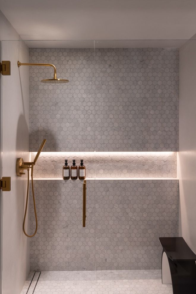 A bathroom with a walk in shower and a sink.