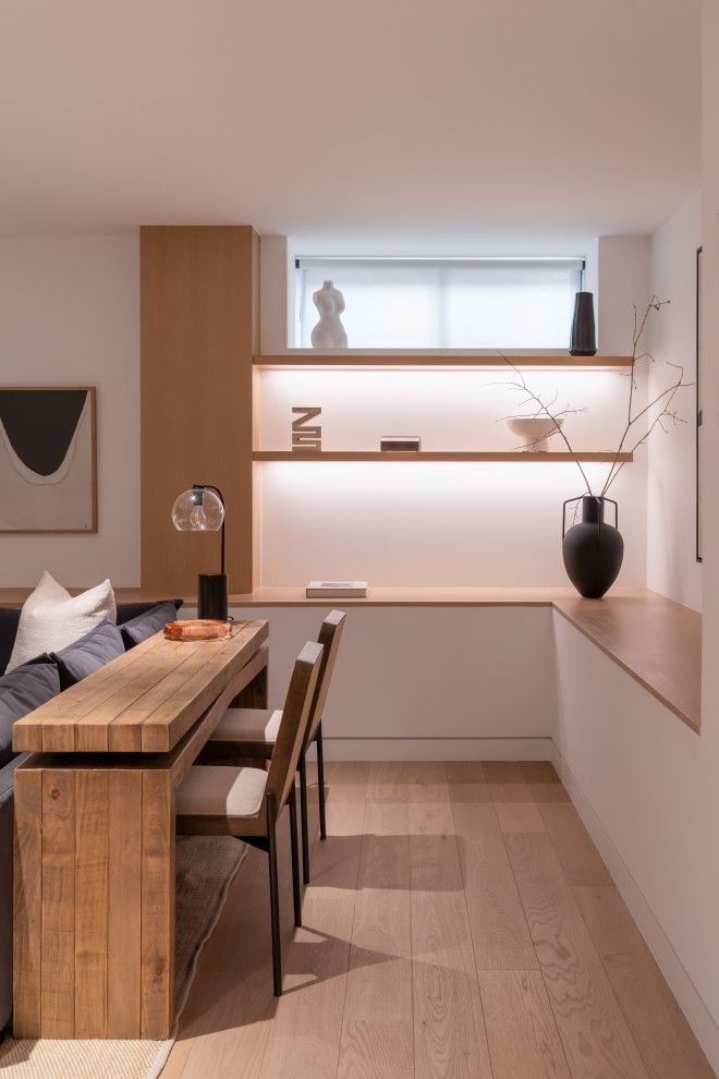A living room with a wooden table and chairs and a couch.