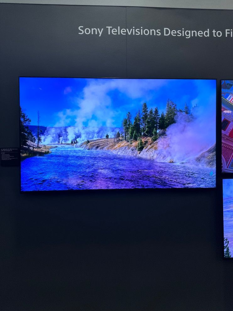 A sony television with a river and trees on it