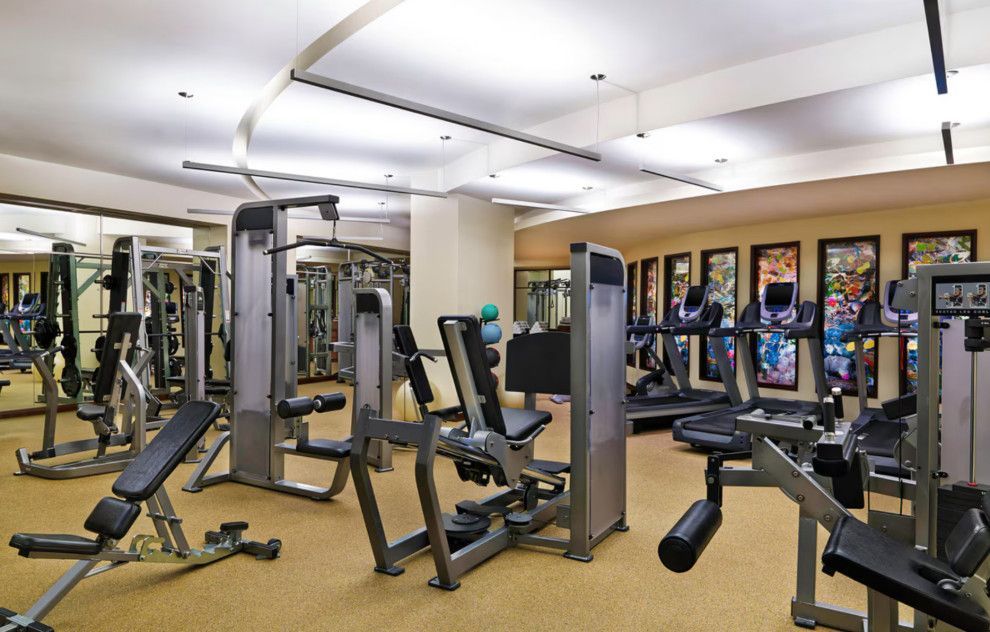 A large gym filled with lots of exercise equipment