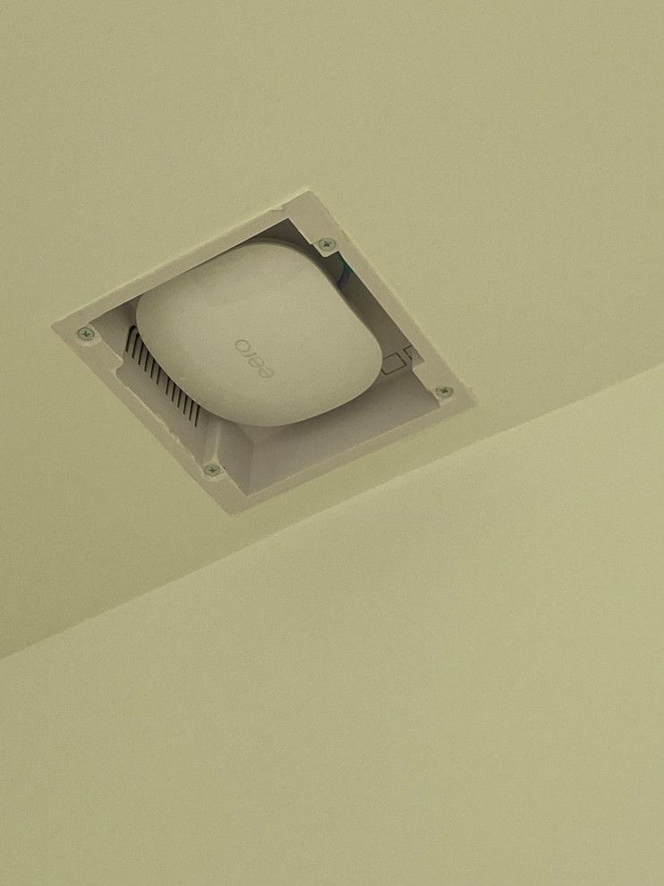 A white box is sitting in the ceiling of a room.