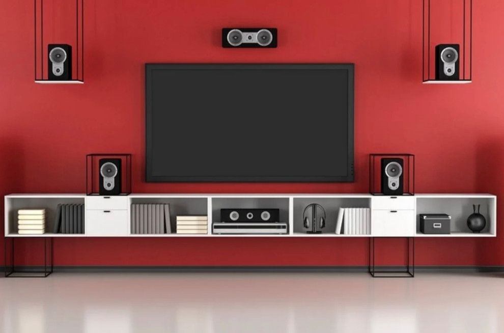 A living room with a flat screen tv and speakers.