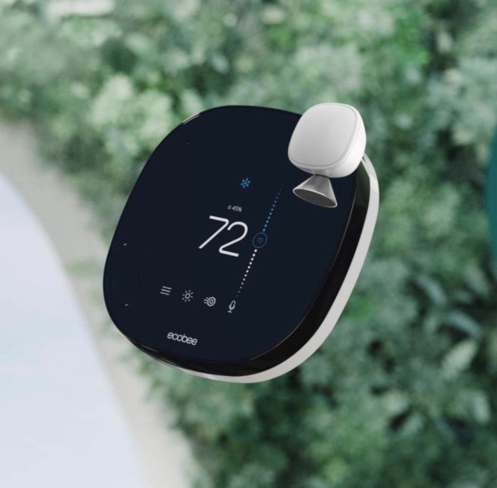 A black and white thermostat with the number 72 on it