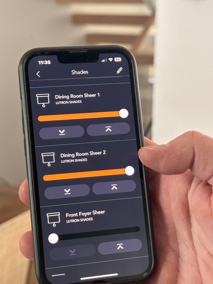 A person is holding a smart phone with a shades app on it