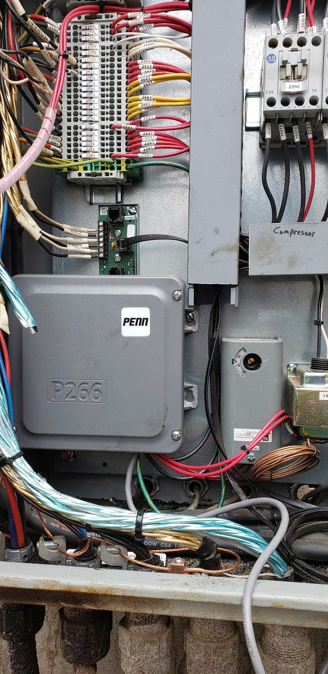 A close up of a electrical box with a lot of wires coming out of it.