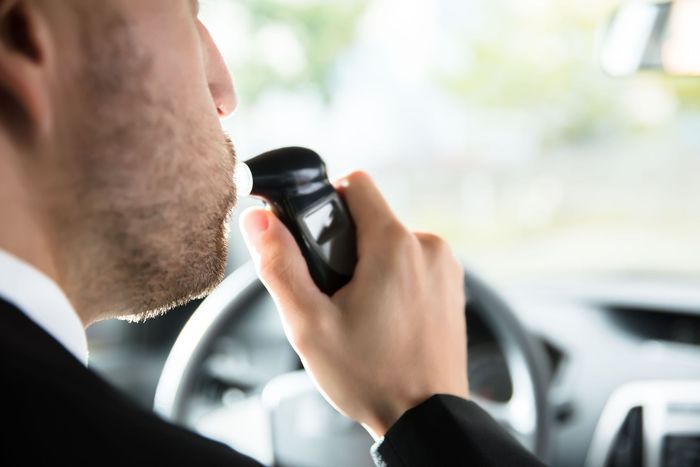 close man sitting inside car taking