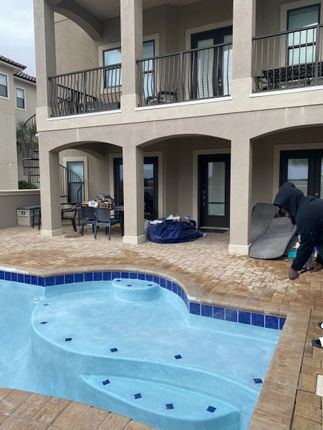 A large house with a swimming pool in front of it
