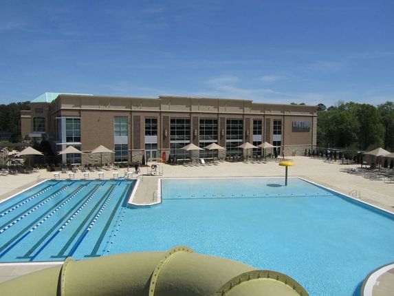 A large building with a swimming pool in front of it