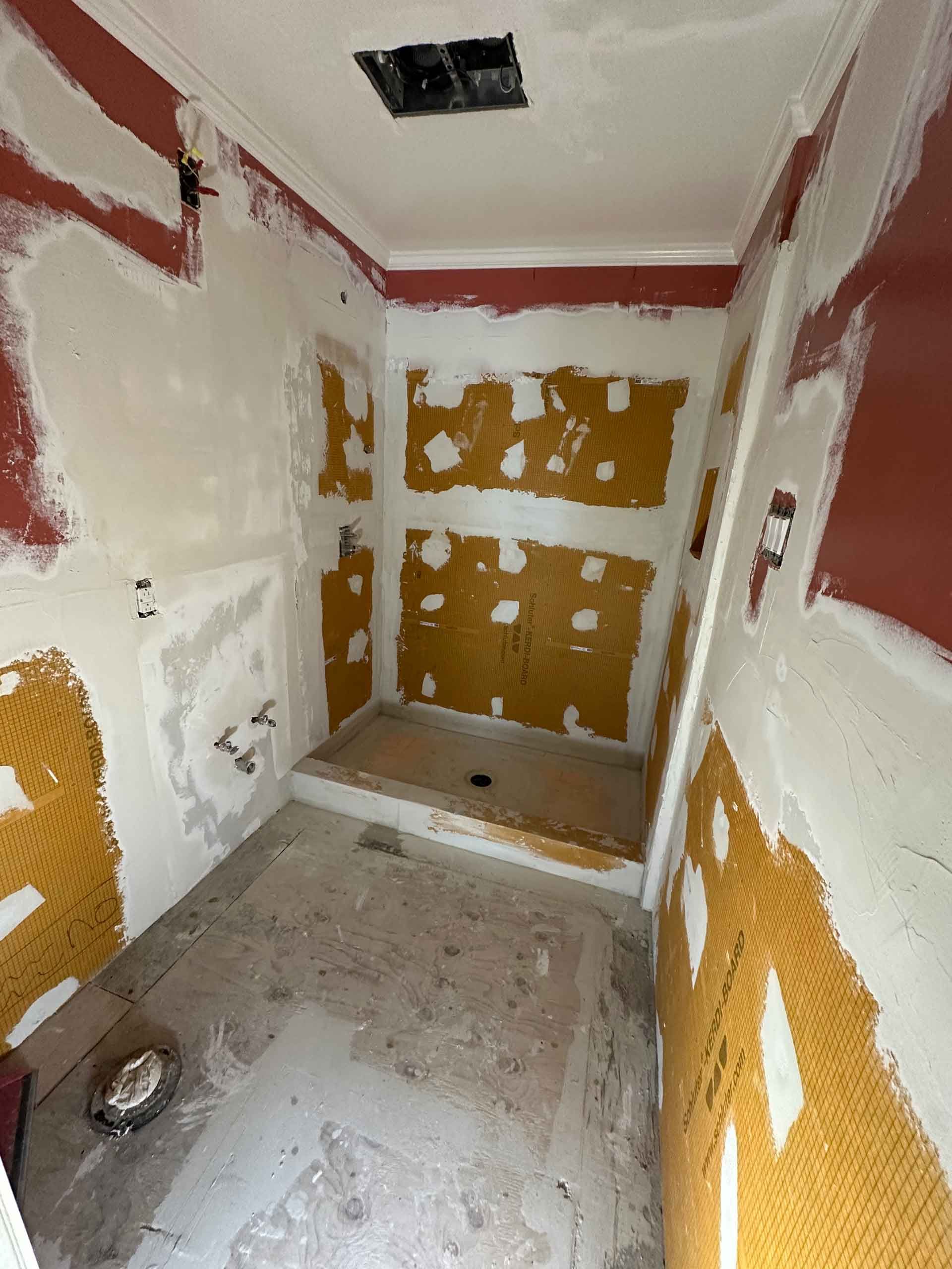 A bathroom that is being remodeled with a shower.