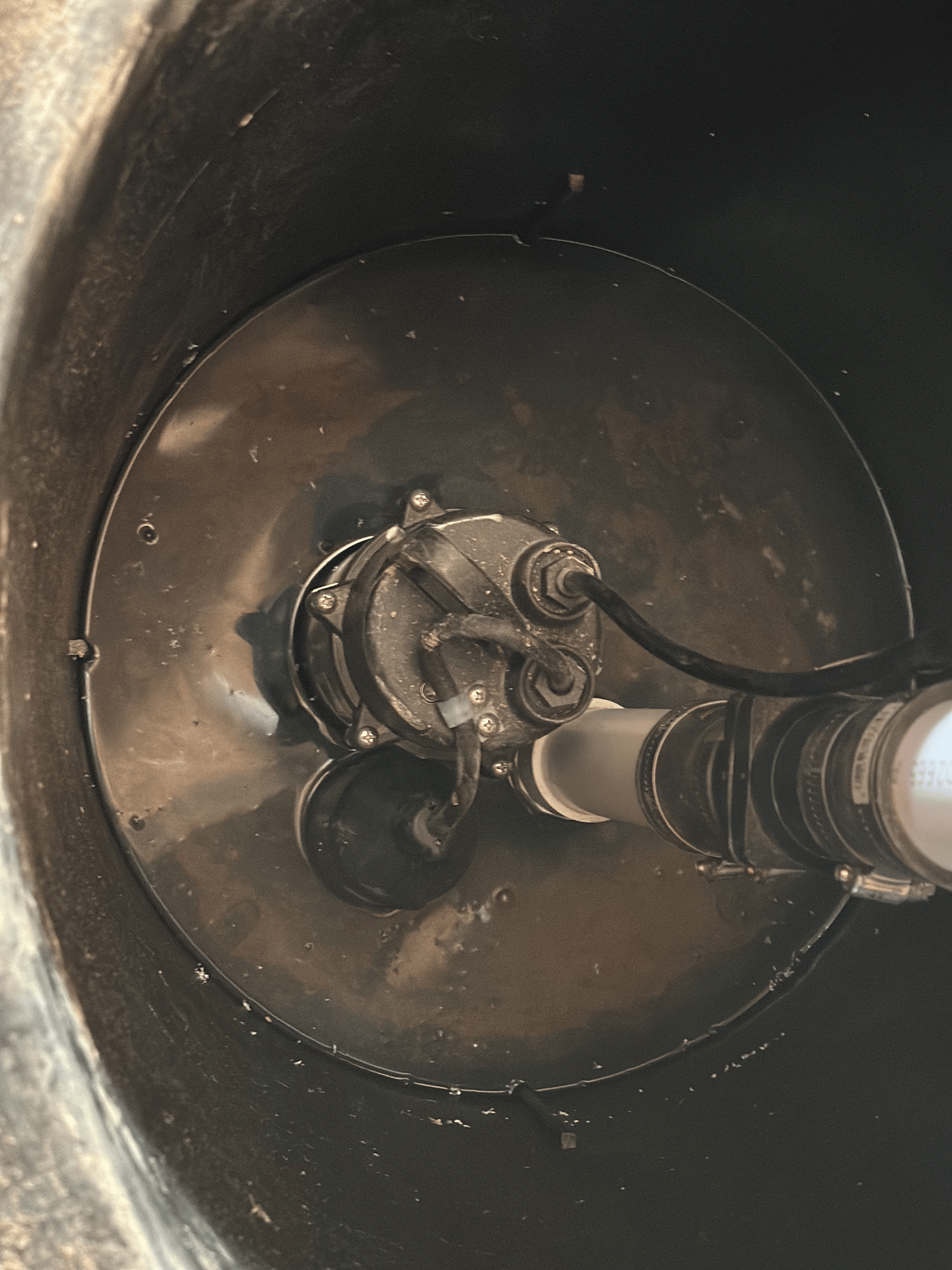 A close up of a drain with a pump in it.