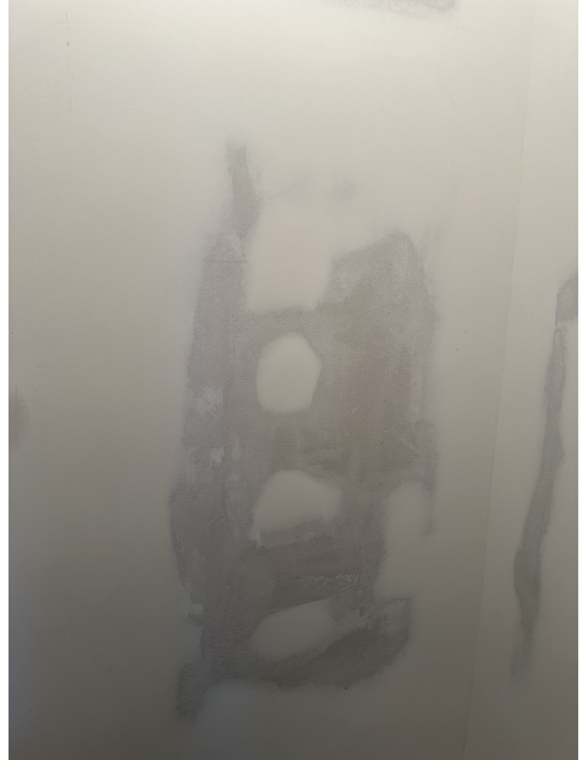 A shadow of a person is visible in the fog.