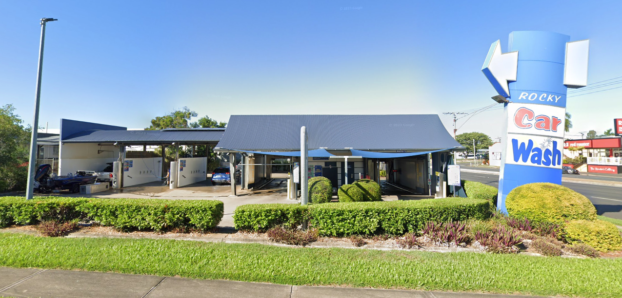A Man Is Polishing A White Car With A Machine — Rocky Car Wash In Berserker, QLD