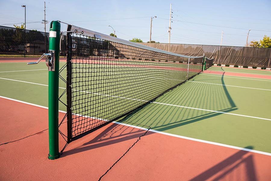 Tennis court surface courting having been completed.