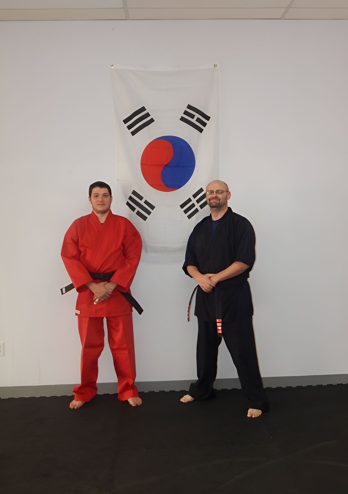 Two men standing in front of a korean flag