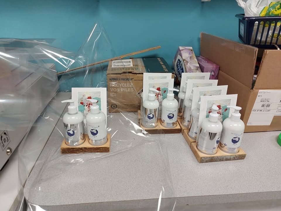 Un tas de bouteilles de désinfectant pour les mains sont posées sur un comptoir.