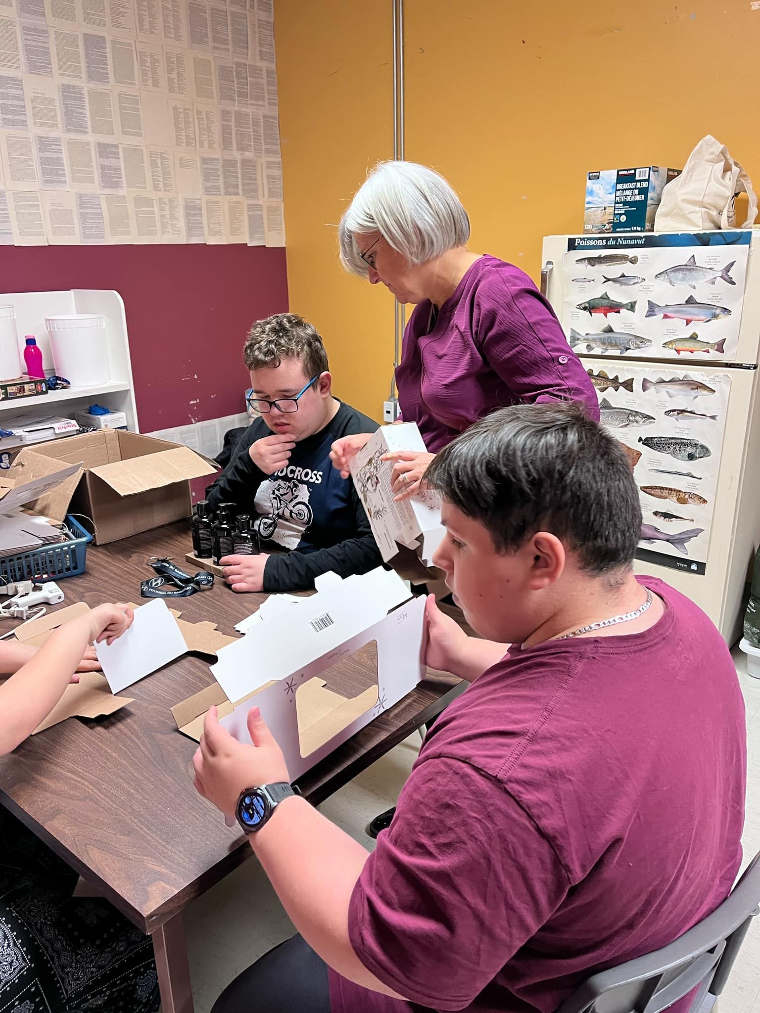 Un groupe de personnes sont assises à une table et travaillent sur un projet.