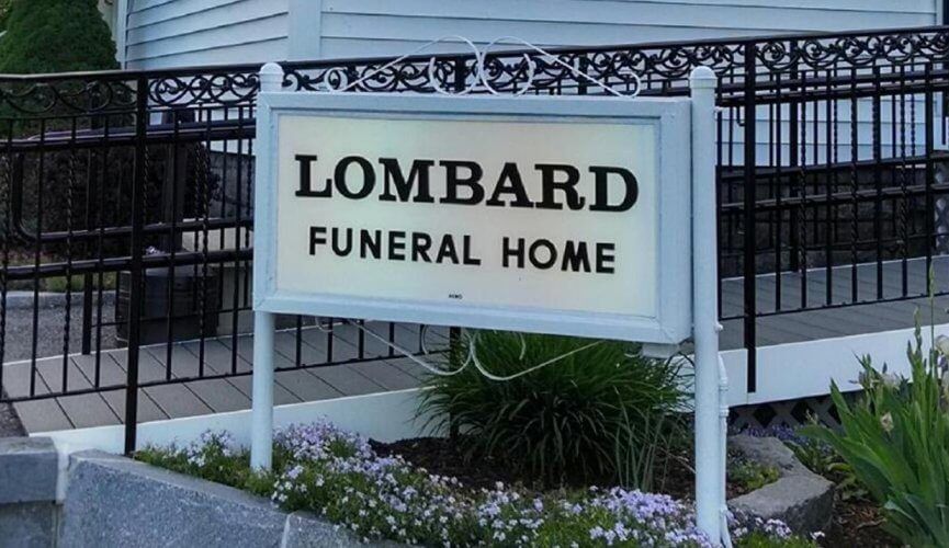 A sign for lombard funeral home is in front of a building