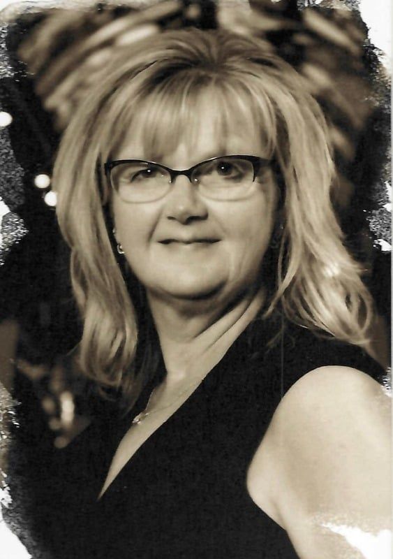 A black and white photo of a woman wearing glasses
