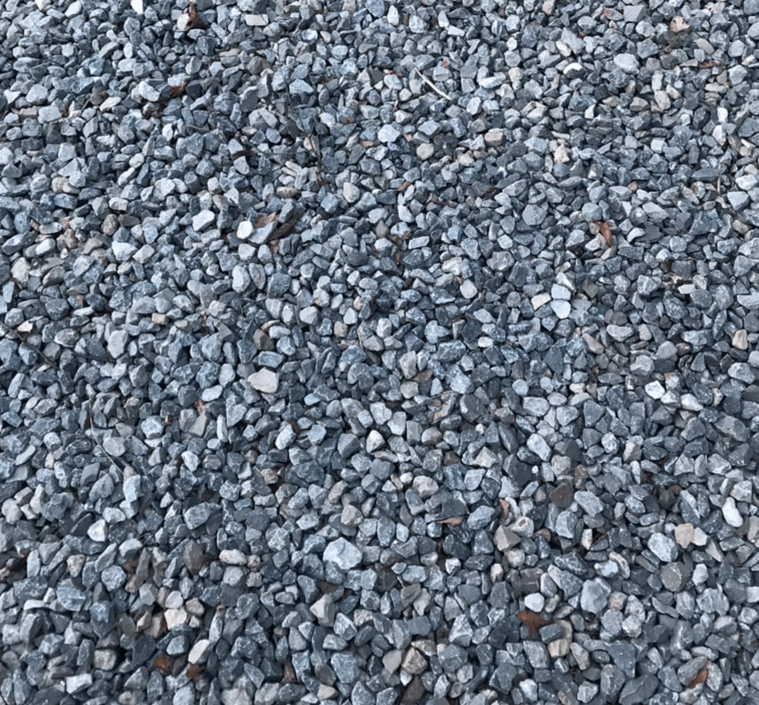 A pile of gravel is sitting on the ground.