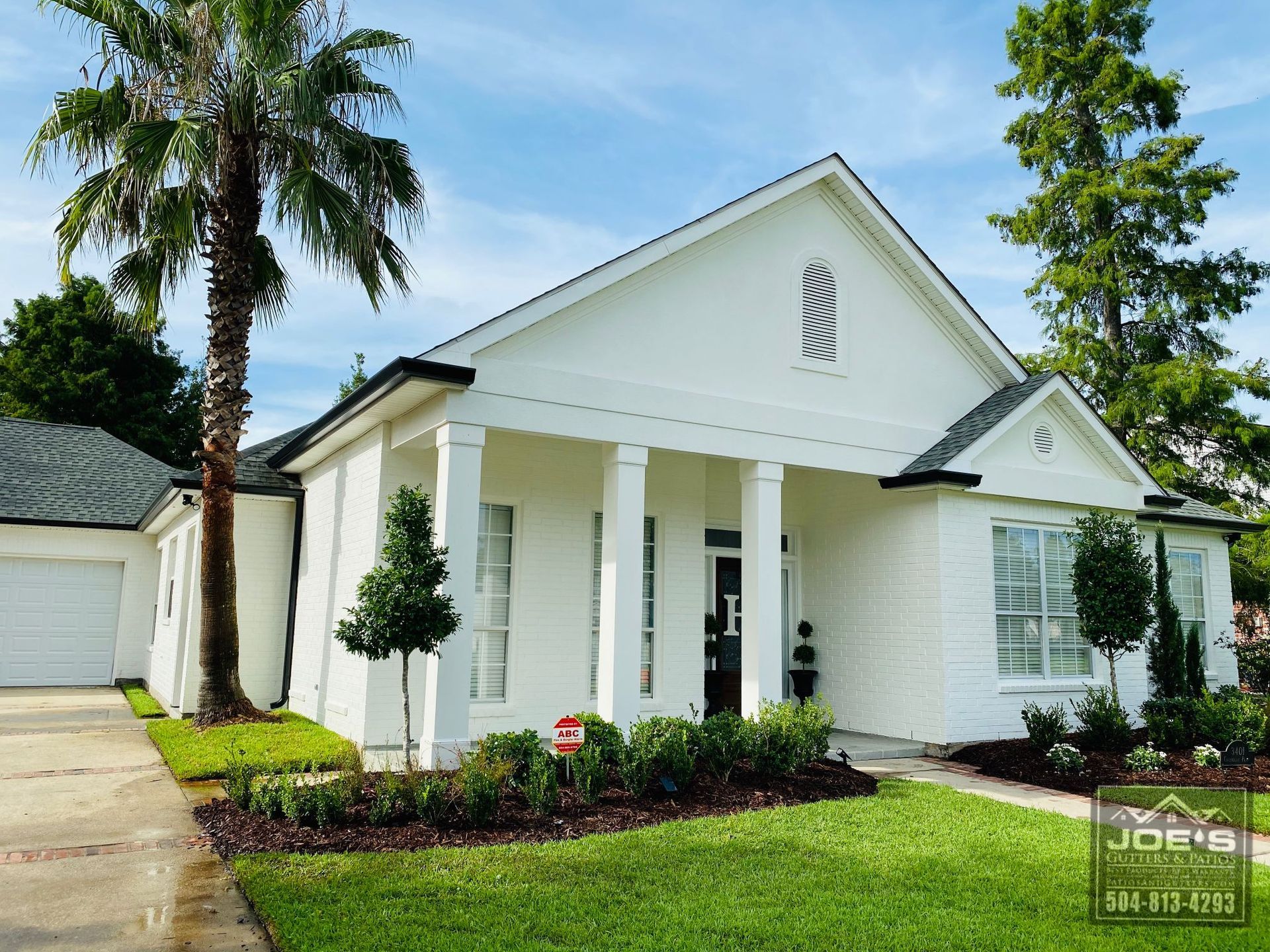 A white house with a stop sign in front of it
