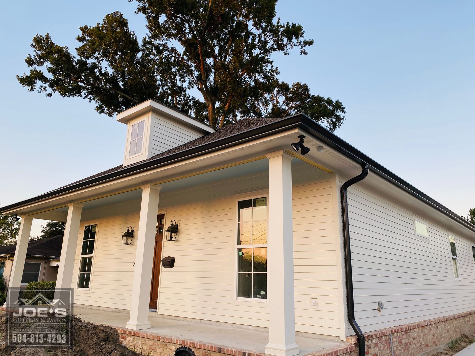 A white house with a porch and a sign that says joe 's