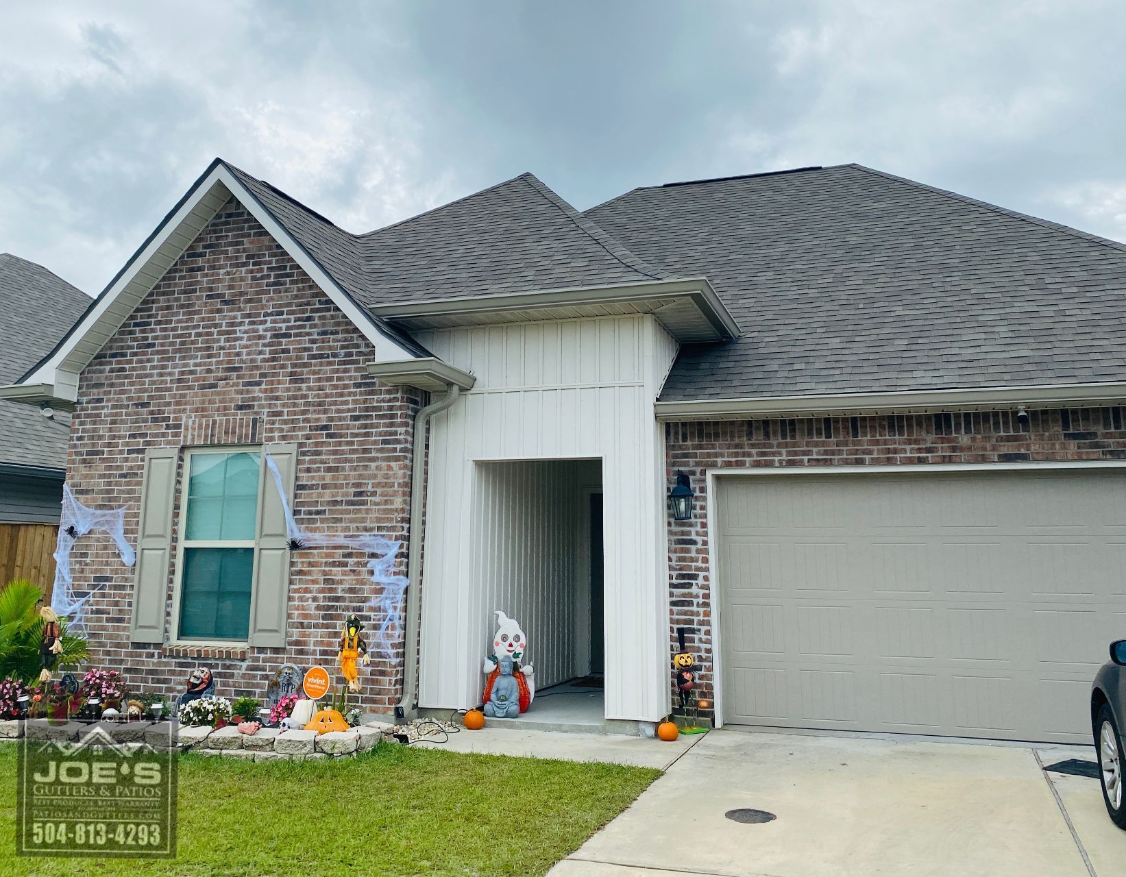 A brick house with a car parked in front of it.