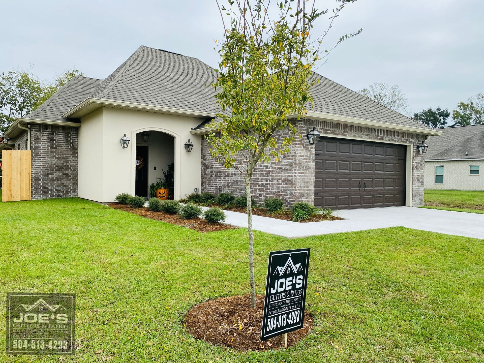 A house for sale with a sign in front of it.