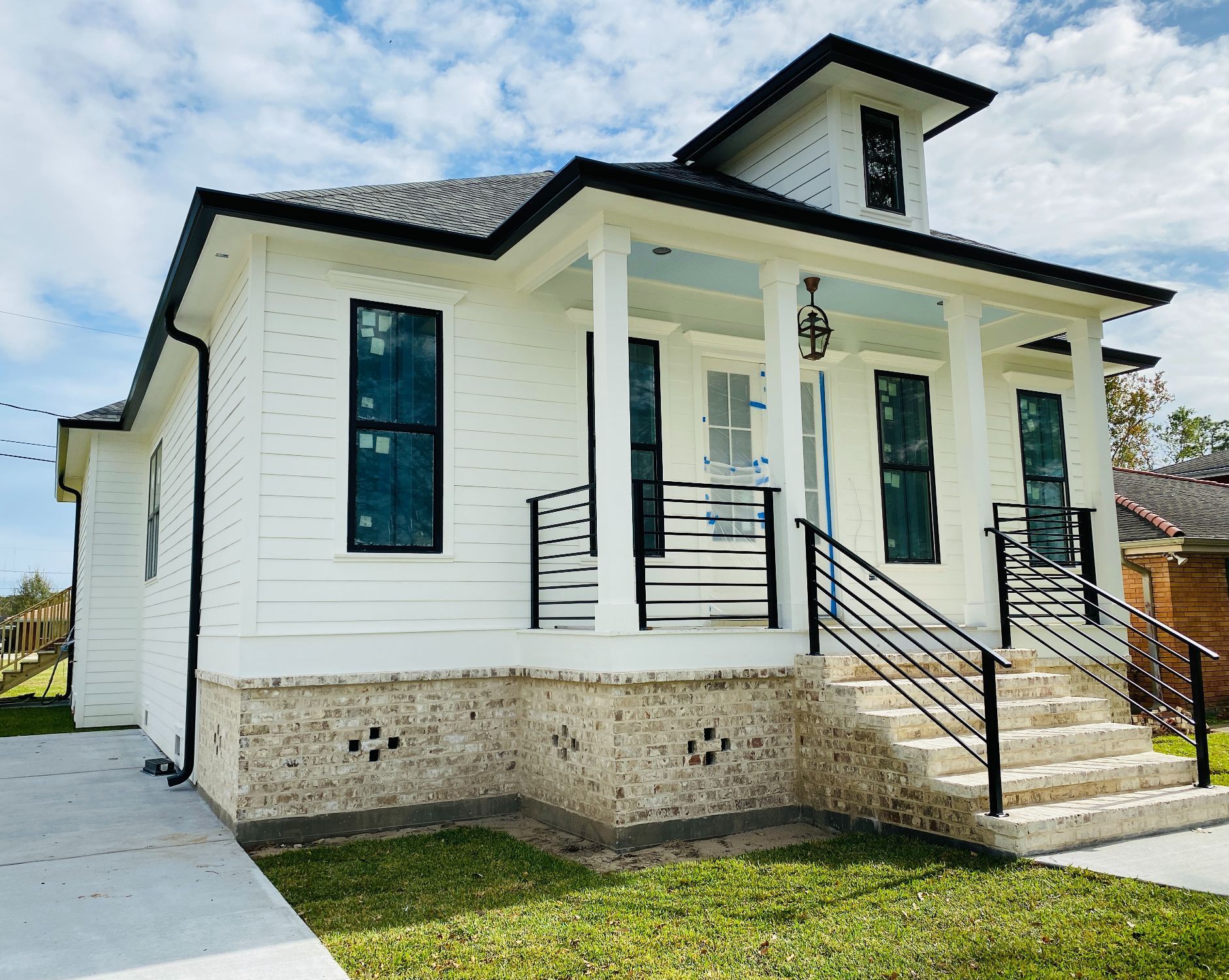 A white house with a porch and stairs