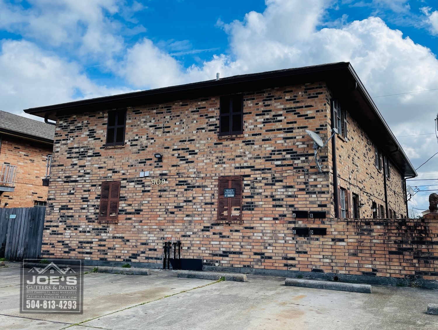 A large brick building with stairs leading up to it is for sale.