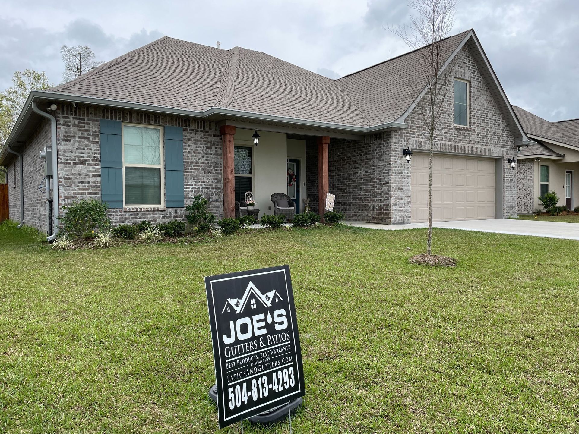 A house with a for sale sign in front of it.