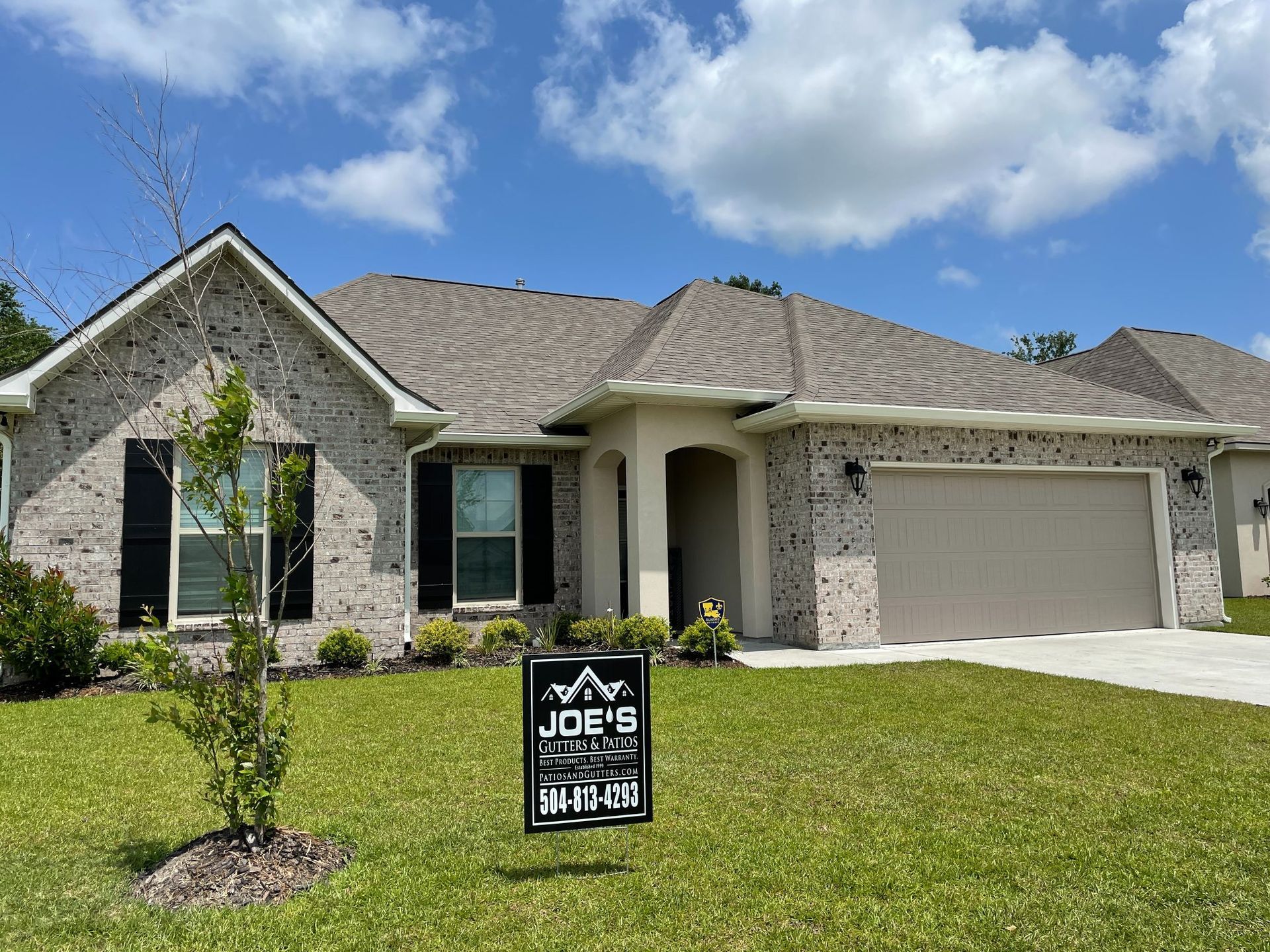 A house with a for sale sign in front of it.