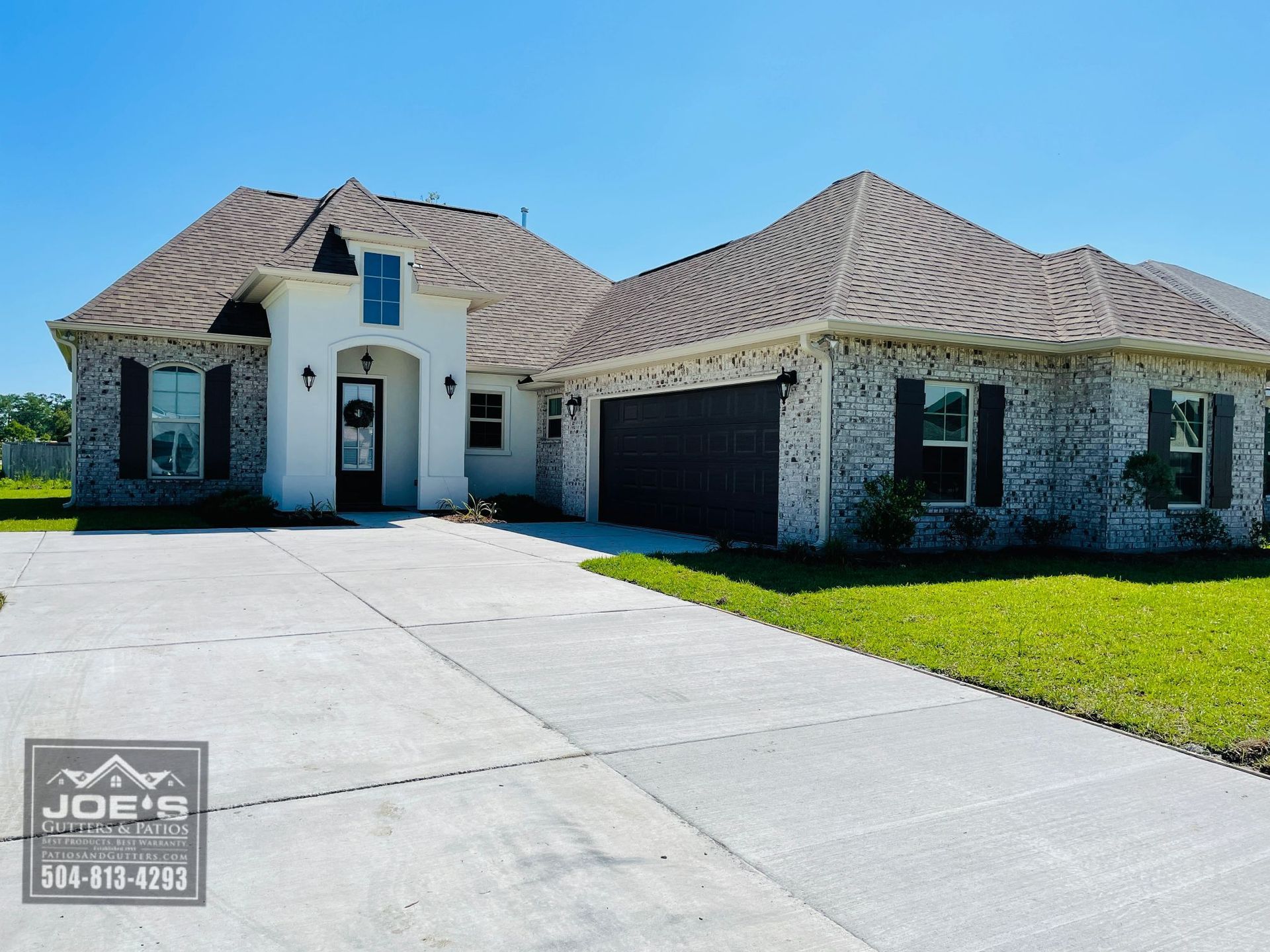 A large white house with a brown roof is for sale