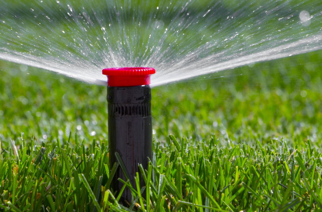 automatic irrigation system on the background of green grass