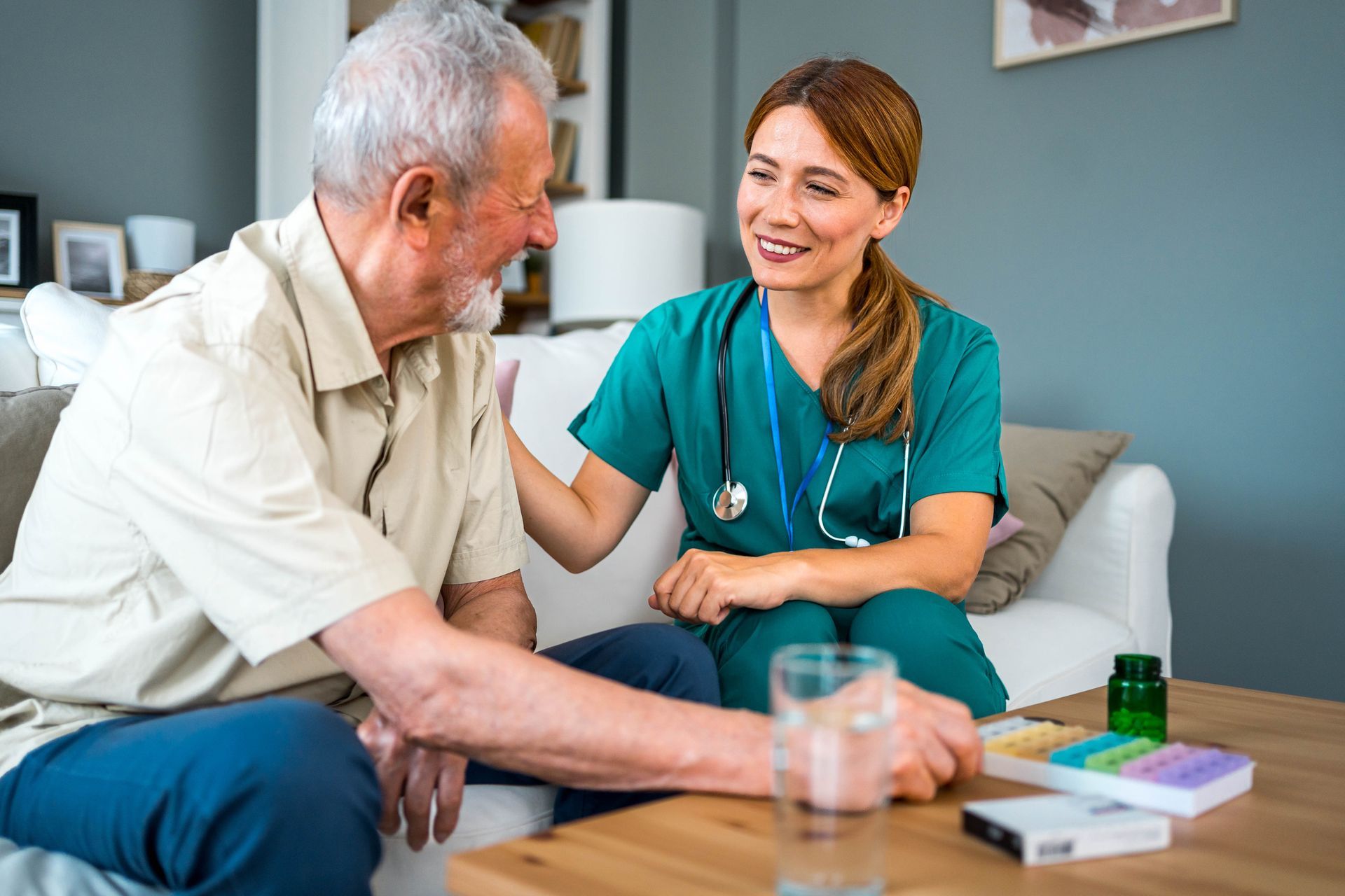 A nurse engages in conversation with an elderly man, offering compassionate senior memory care.