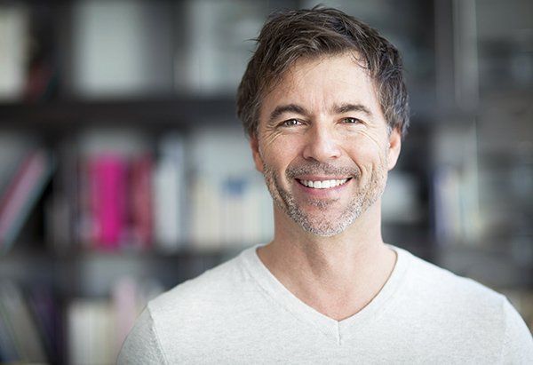 Man With White Shirt — Burleigh Denture Clinic in Burleigh Heads, QLD