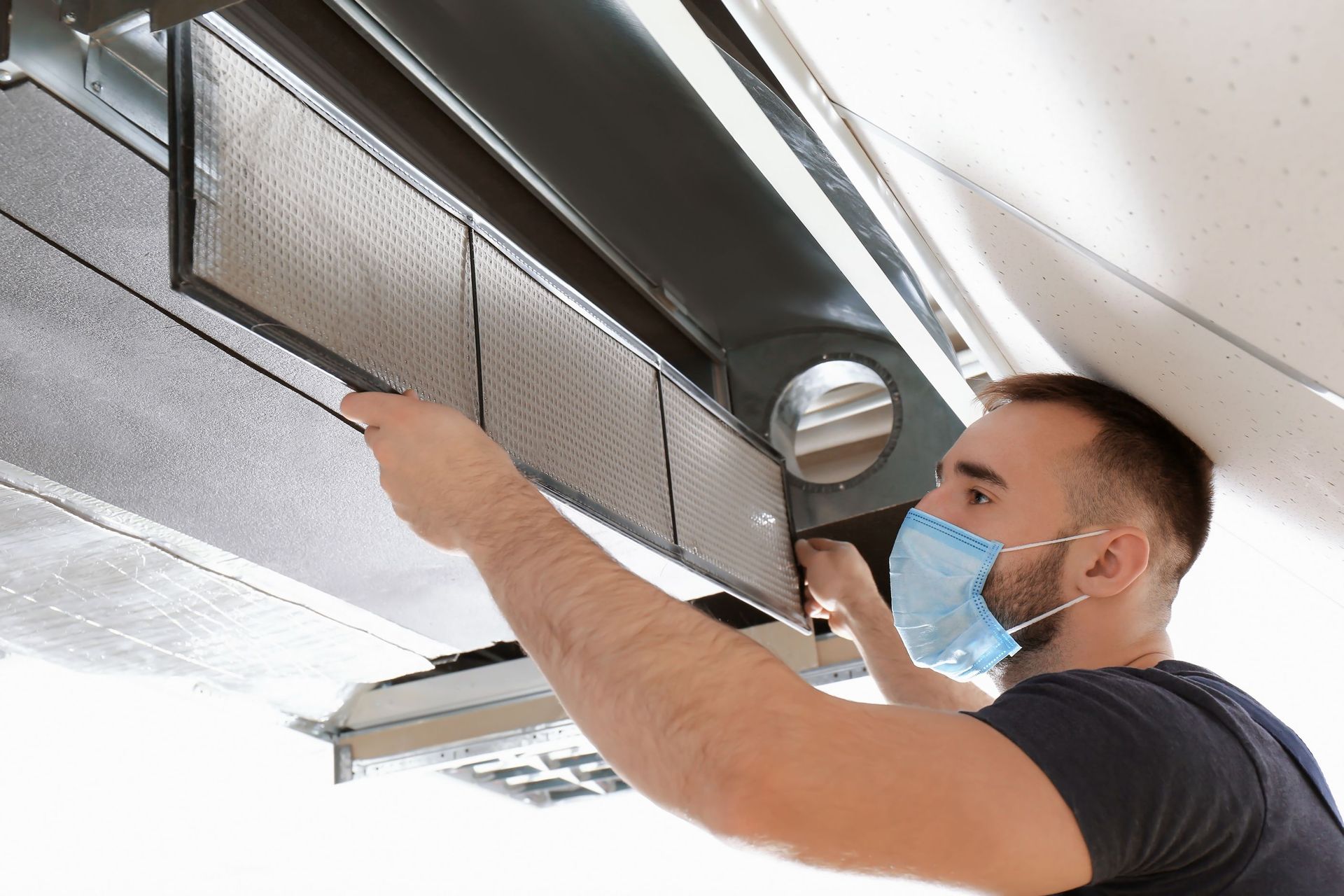 male technician closing an industrial air conditioner