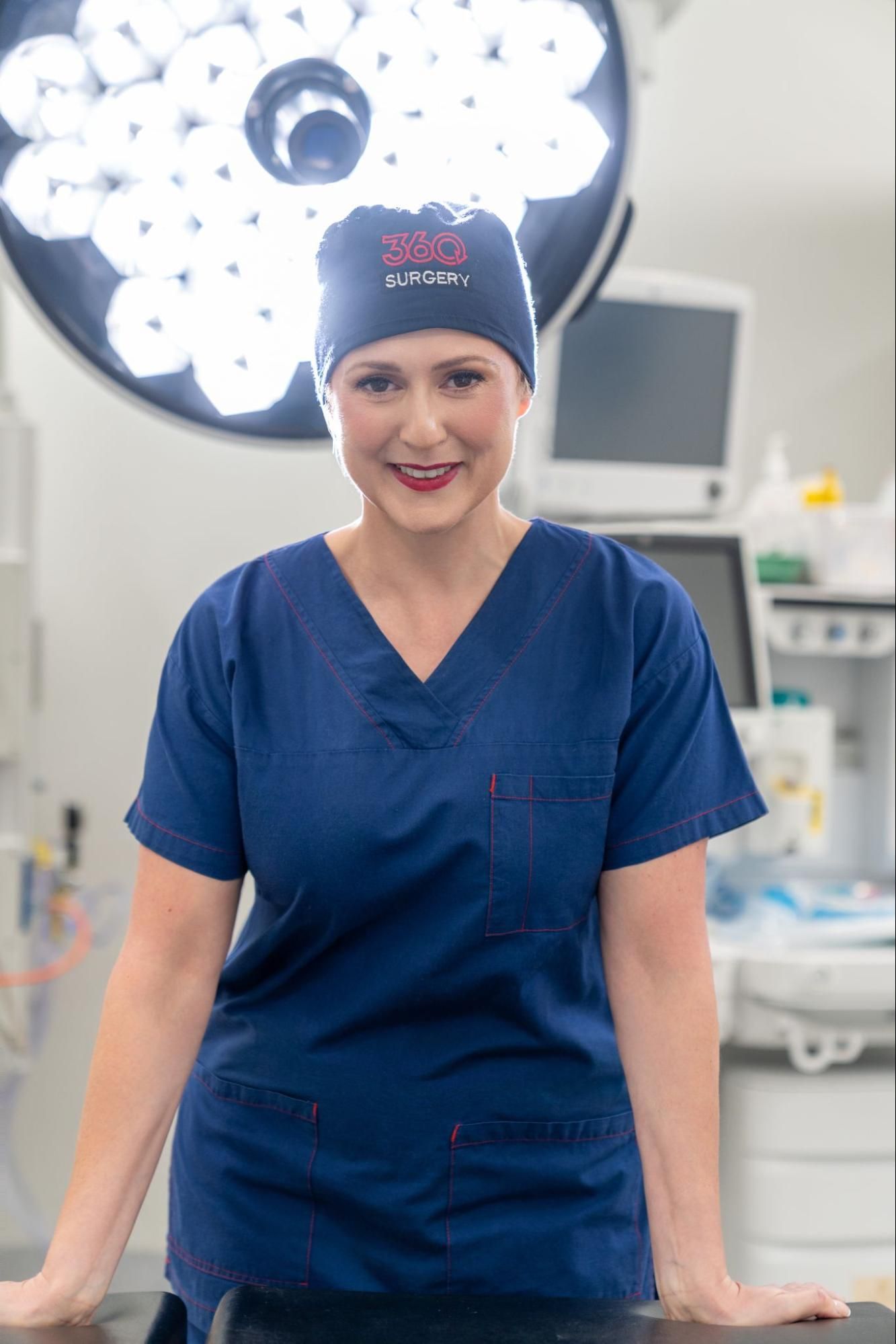 Dr Beitner in an operating theatre with surgical lights