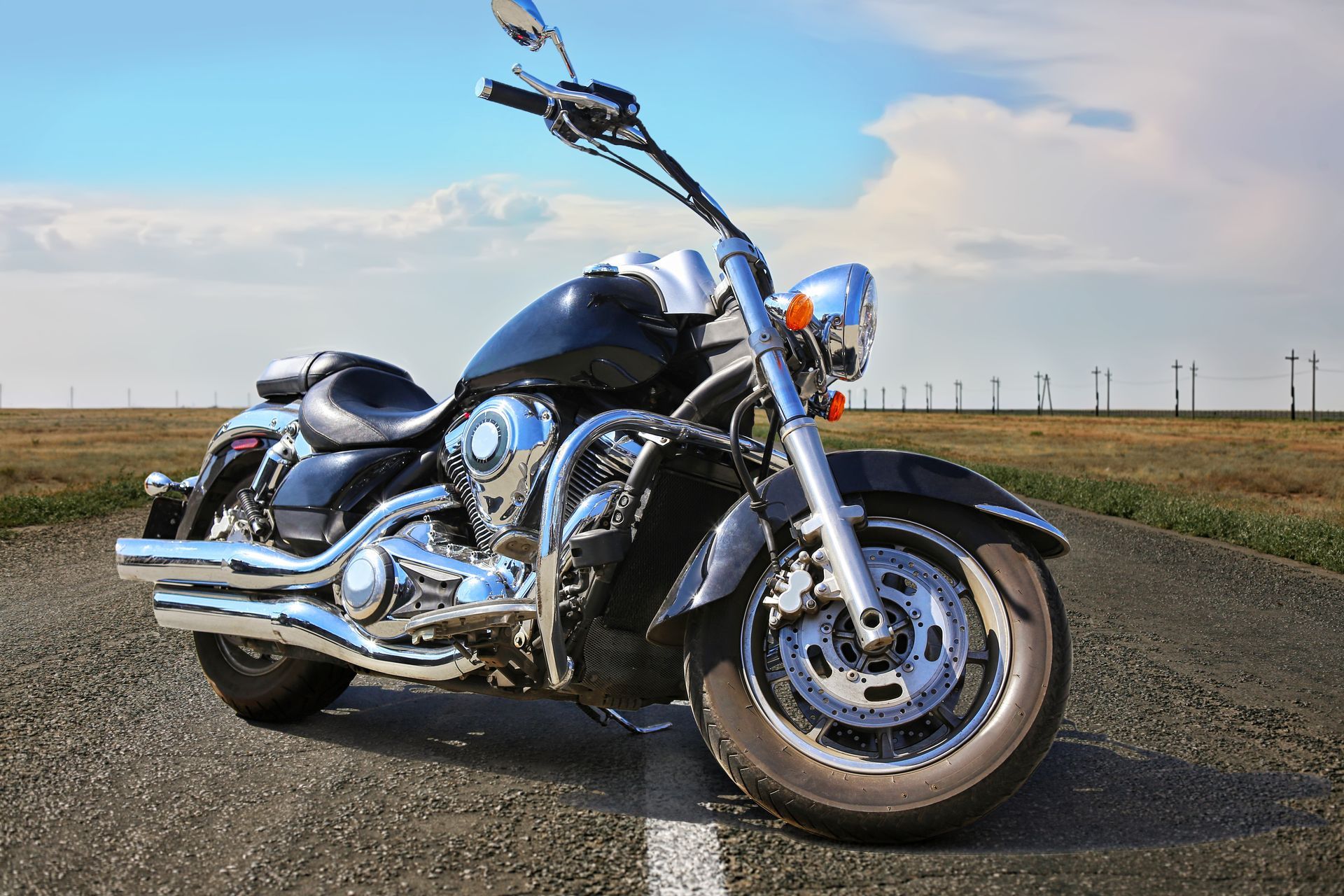 A black and red motorcycle is parked on a white background.