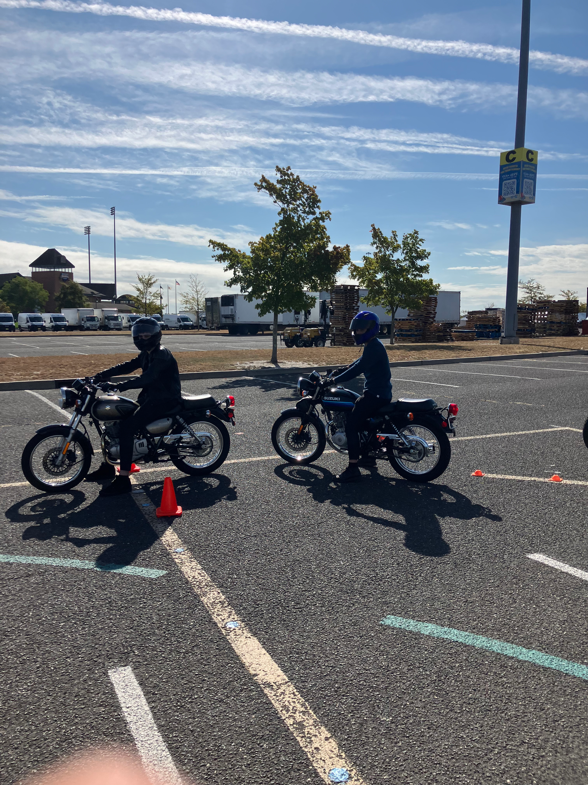 A man is riding a motorcycle down a road.