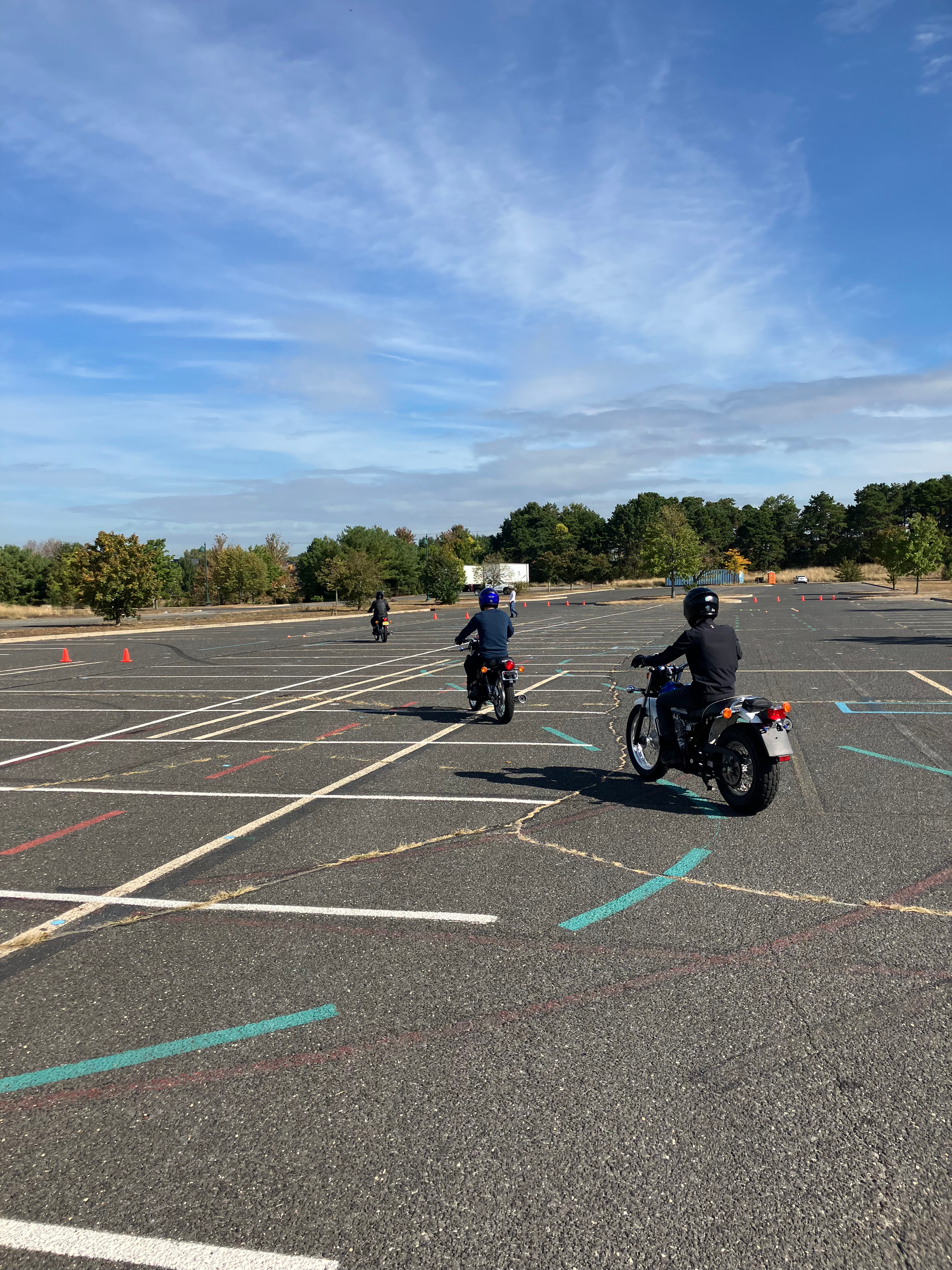 Two men are riding motorcycles down a mountain road.