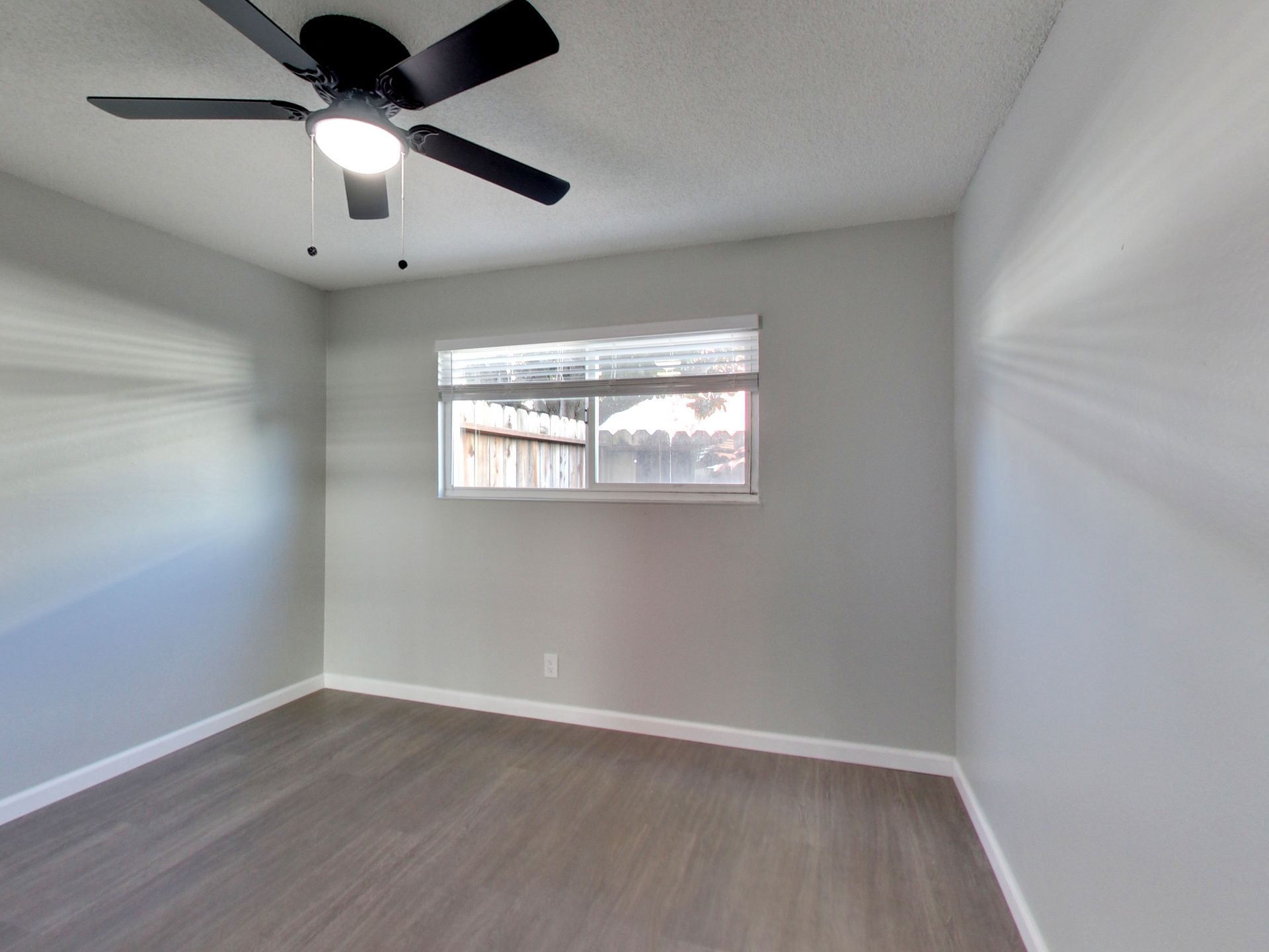 modern living room with a sofa, coffee table, bench, chair, tv and onlooking to a patio