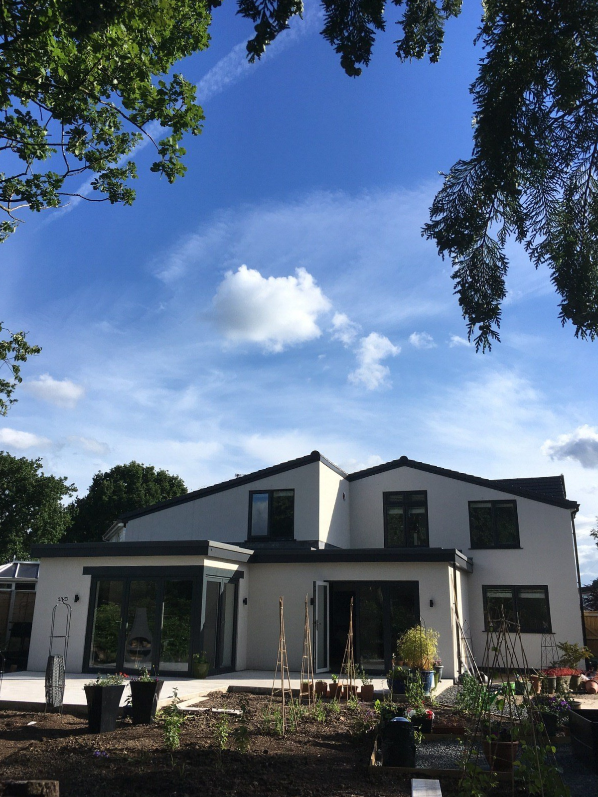Rear elevation of modern rendered home in Cheshire, refurbished from a dated bungalow by Rawlinson Construction