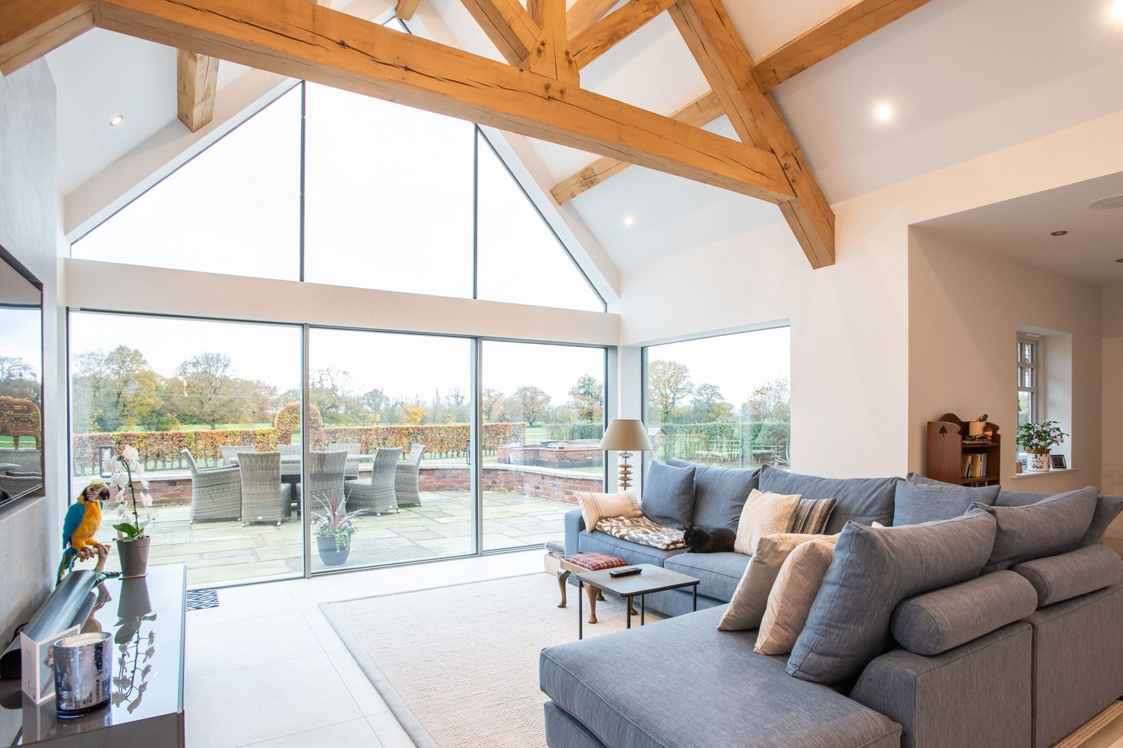 Living area of new-build Cheshire home featuring large glazed windows and Cheshire countryside views