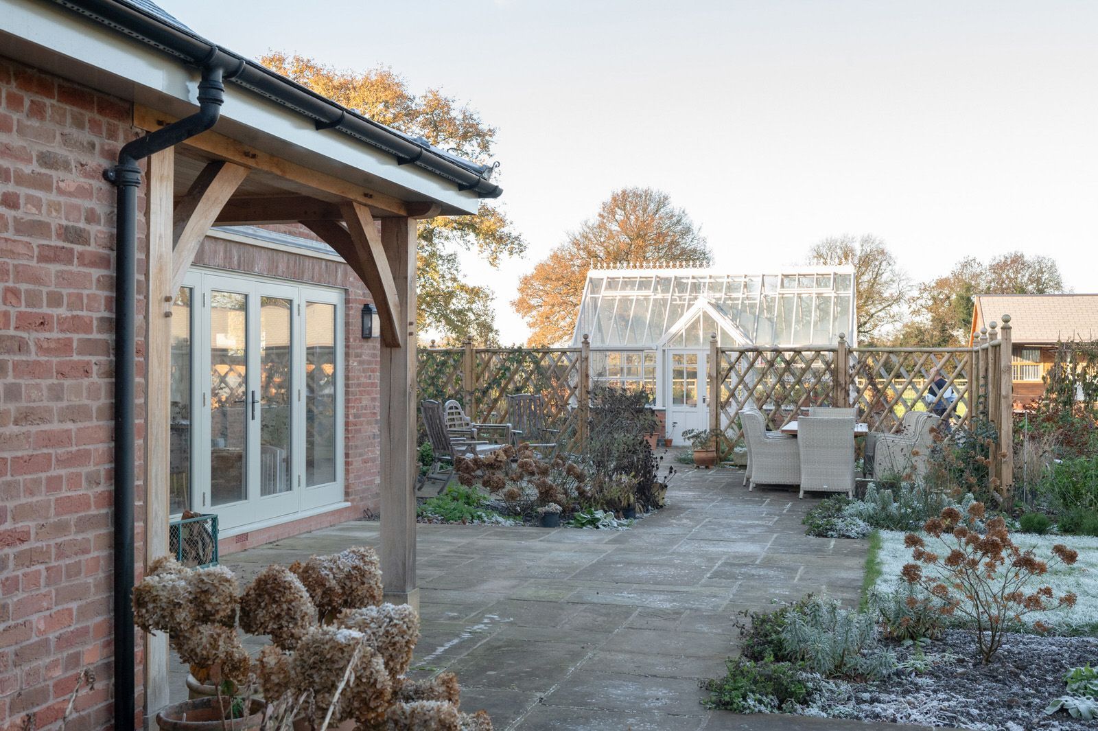 Outdoor living space of Cheshire new build with timber beams