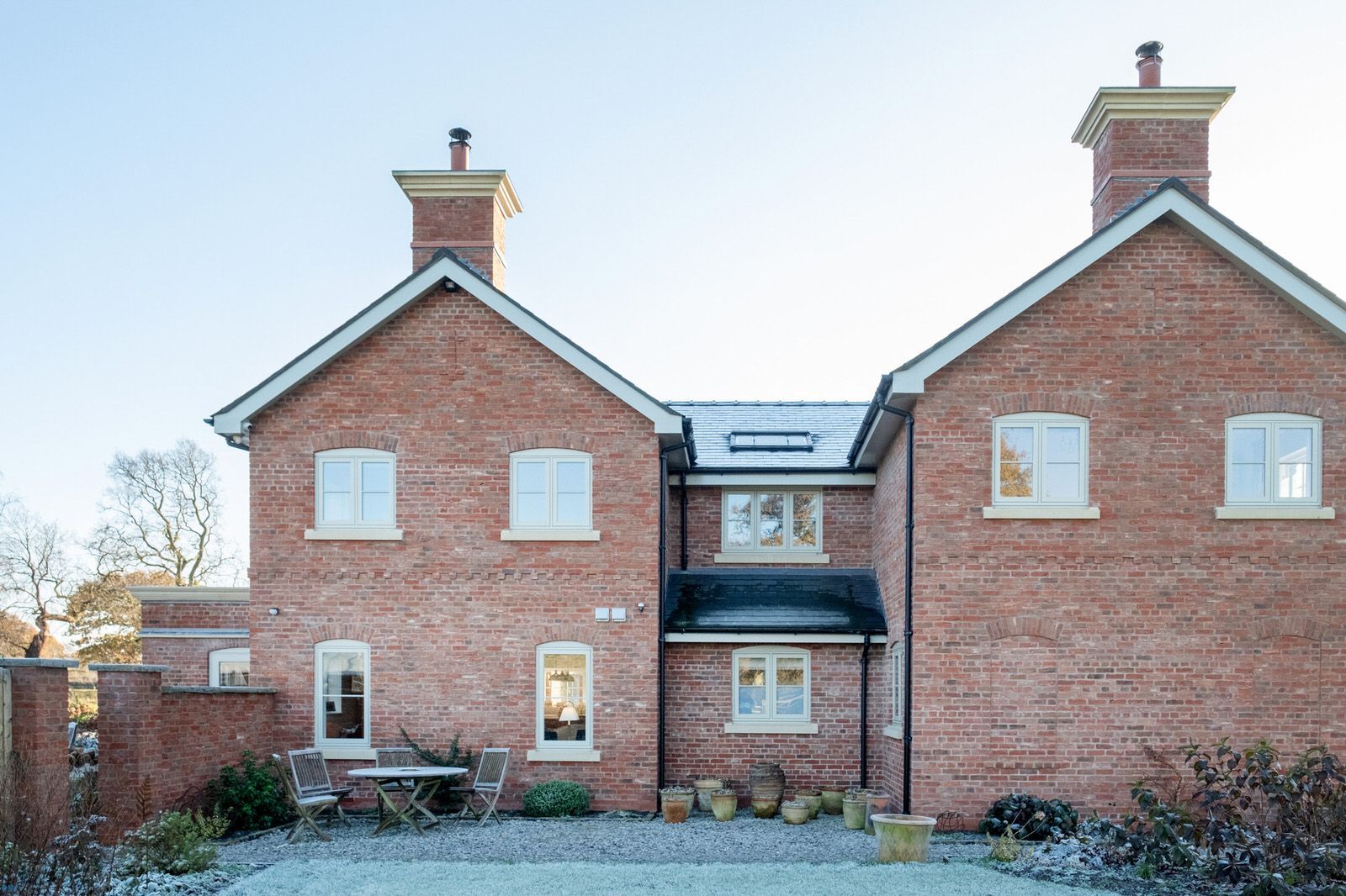 Exterior view of traditional country house blending modern construction with classic farmhouse character