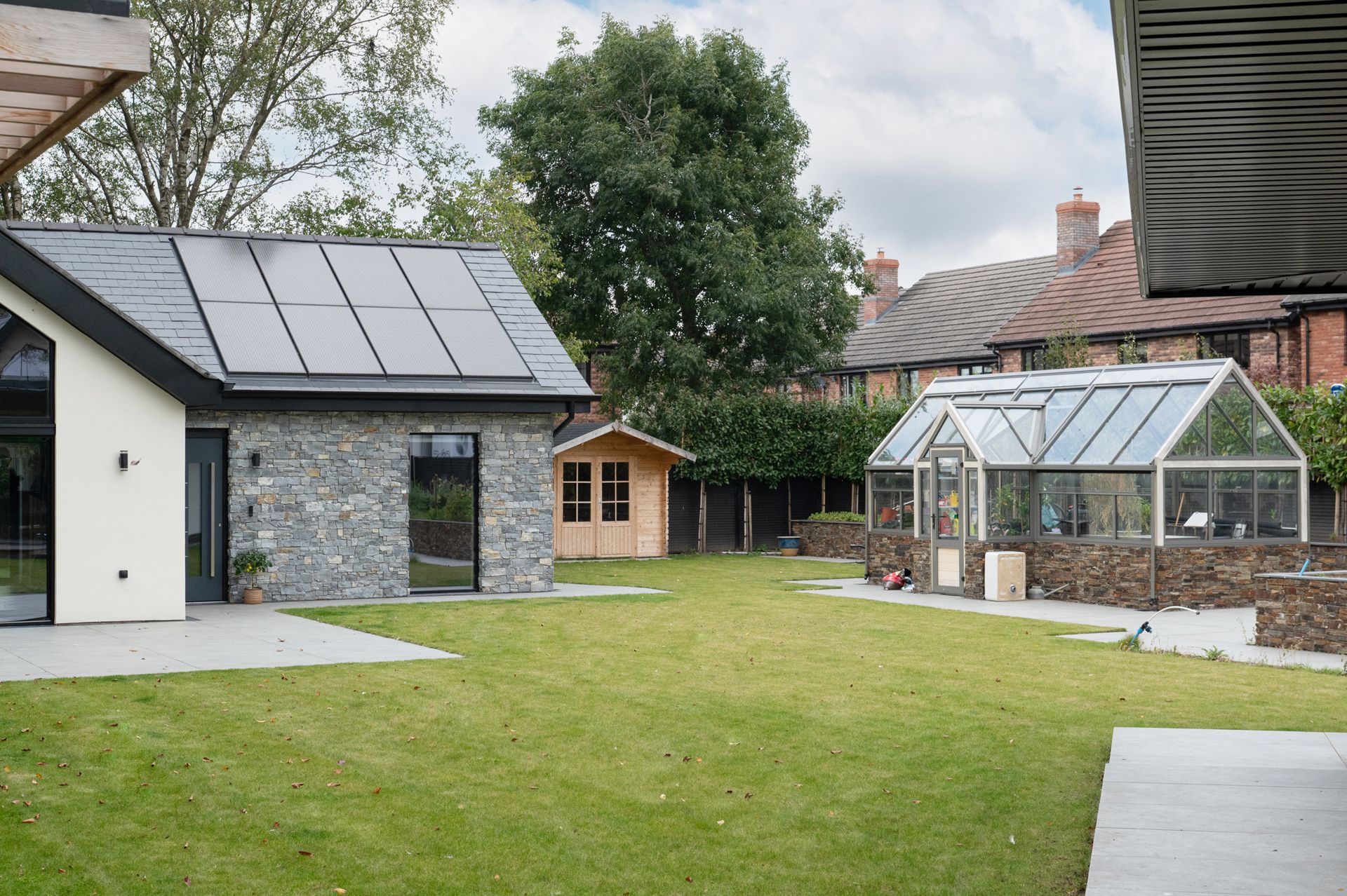 Exterior view highlighting modern finishes and outbuildings at a Sandbach property constructed by Rawlinson Construction