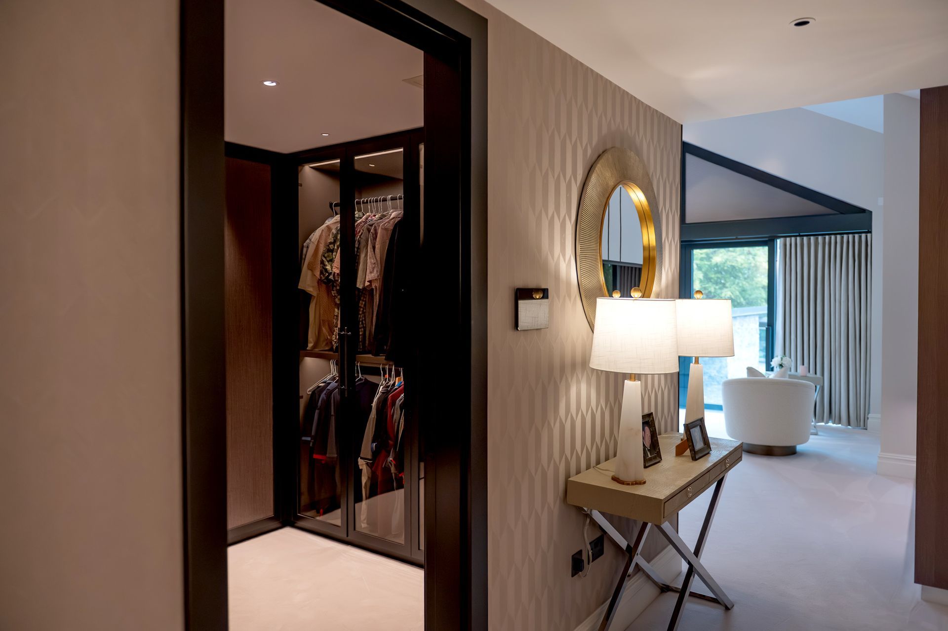 Luxury bedroom with walk in wardrobe in bespoke property built by Rawlinson Construction