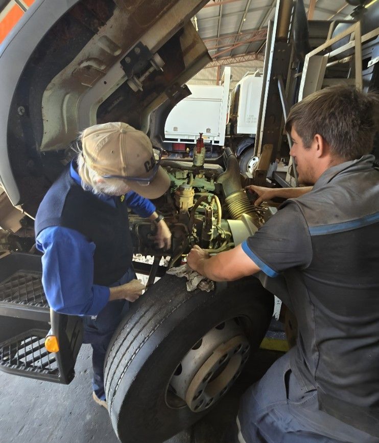 Two Men Are Working On A Truck With The Hood Up — Central Diesel Services In Alice Springs, NT